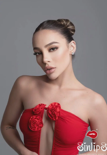 Alpine, charming blonde Brazilian escort in London (Paddington) wearing a red dress with no bra