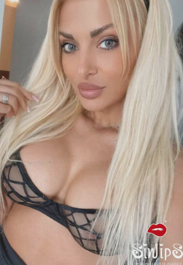 Cynthia, showing her breasts in a black bra