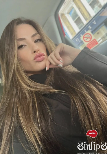 Mercedes, Brazilian escort in London taking a selfie in a car