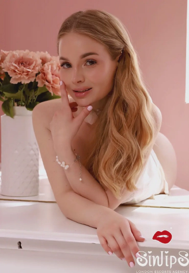 Milasha, busty blonde escort in bed